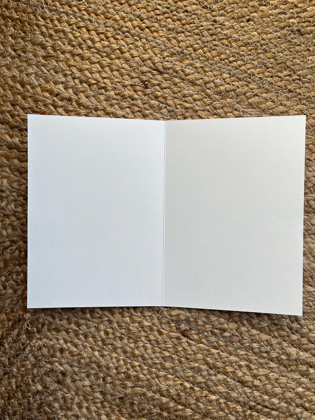 Open white card (blank) on a yute rug